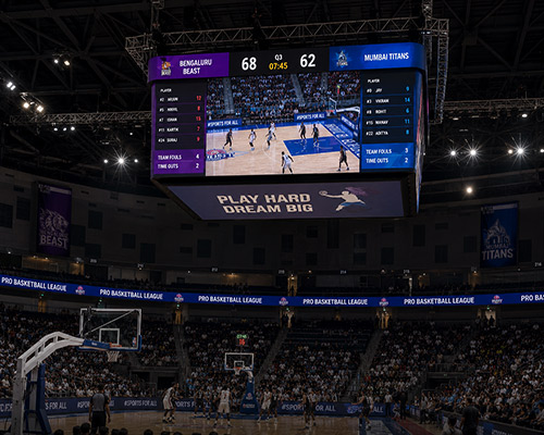 Large center-hung LED display providing immersive viewing inside an arena.