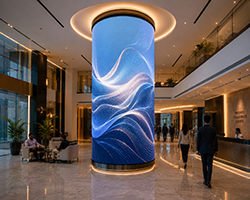 Cylindrical 360-degree LED column displaying seamless digital content in public spaces.