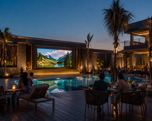 Outdoor LED display installed near a hotel poolside for entertainment and communication.